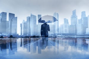 Man Standing Under Umbrella - What To Consider When Hiring A New AMC