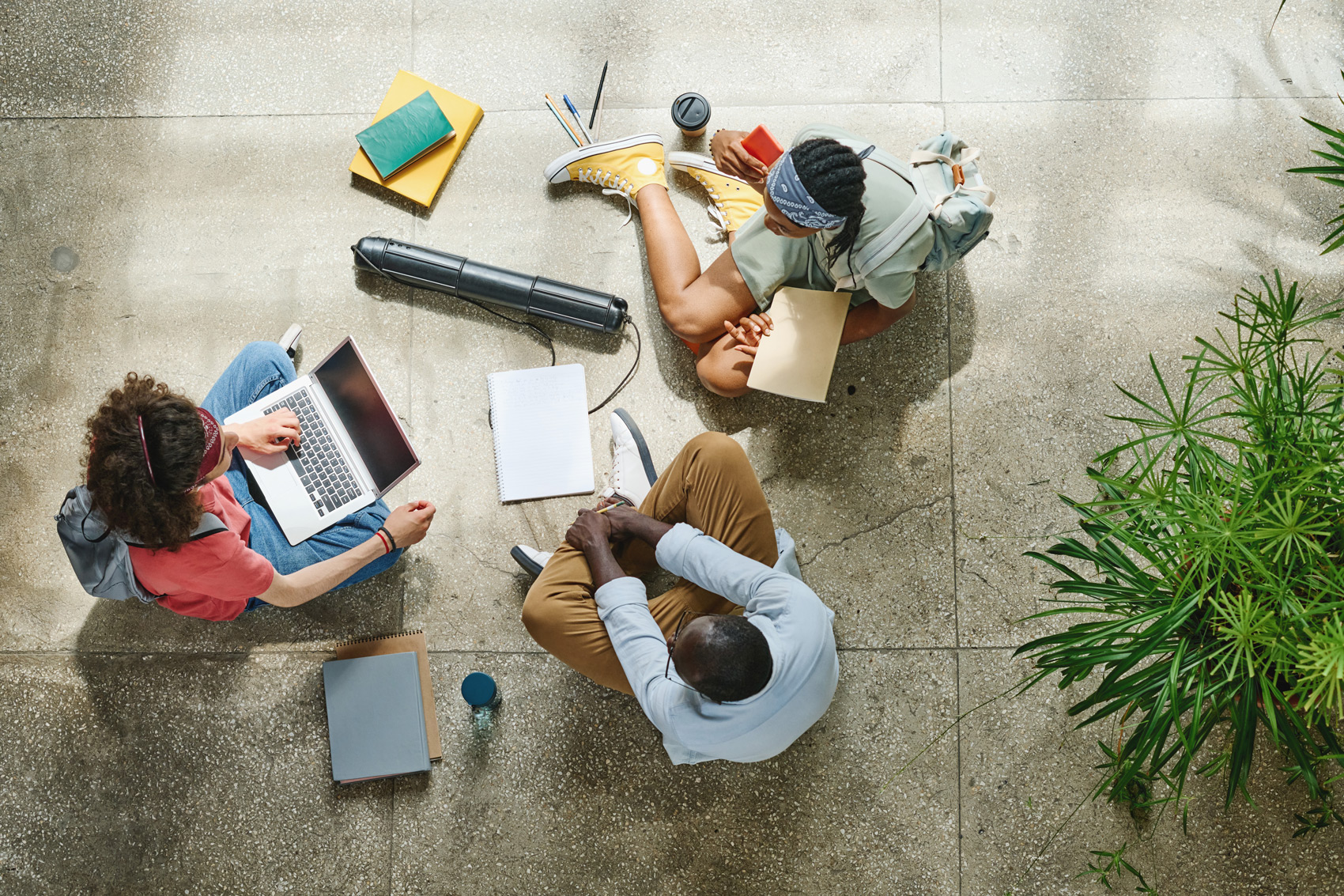 College Students Sitting on Floor With Laptop And Books - Latest Employee Trends 