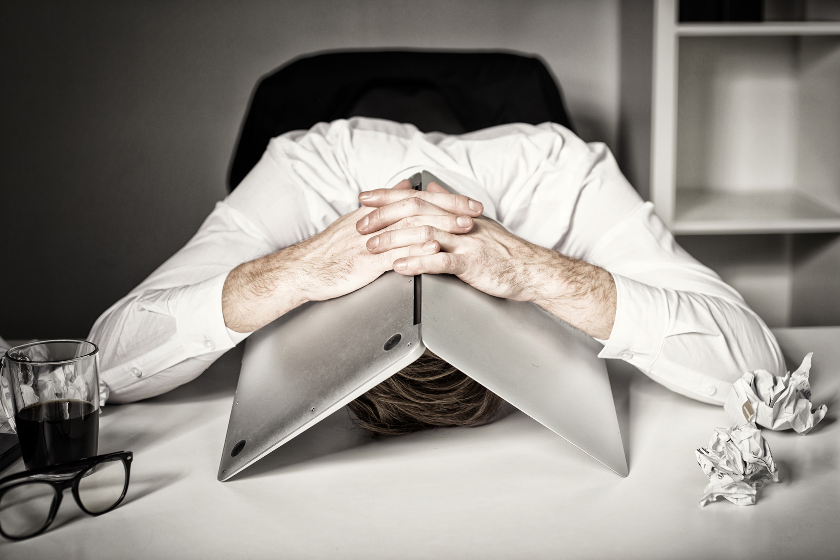 Preventing Email Fatigue - Man in Office With Laptop Over His Head