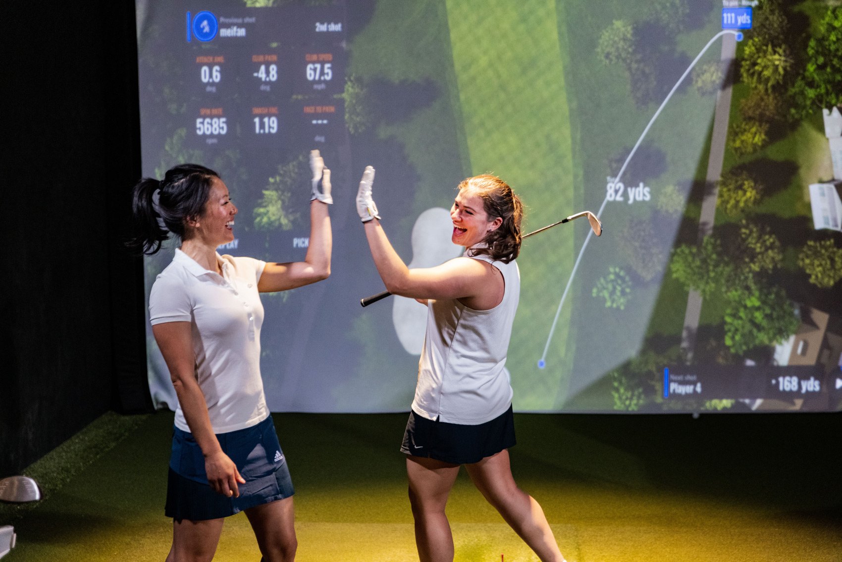 Team Building Activities for Executives - Two Women Executives in Golf Simulator